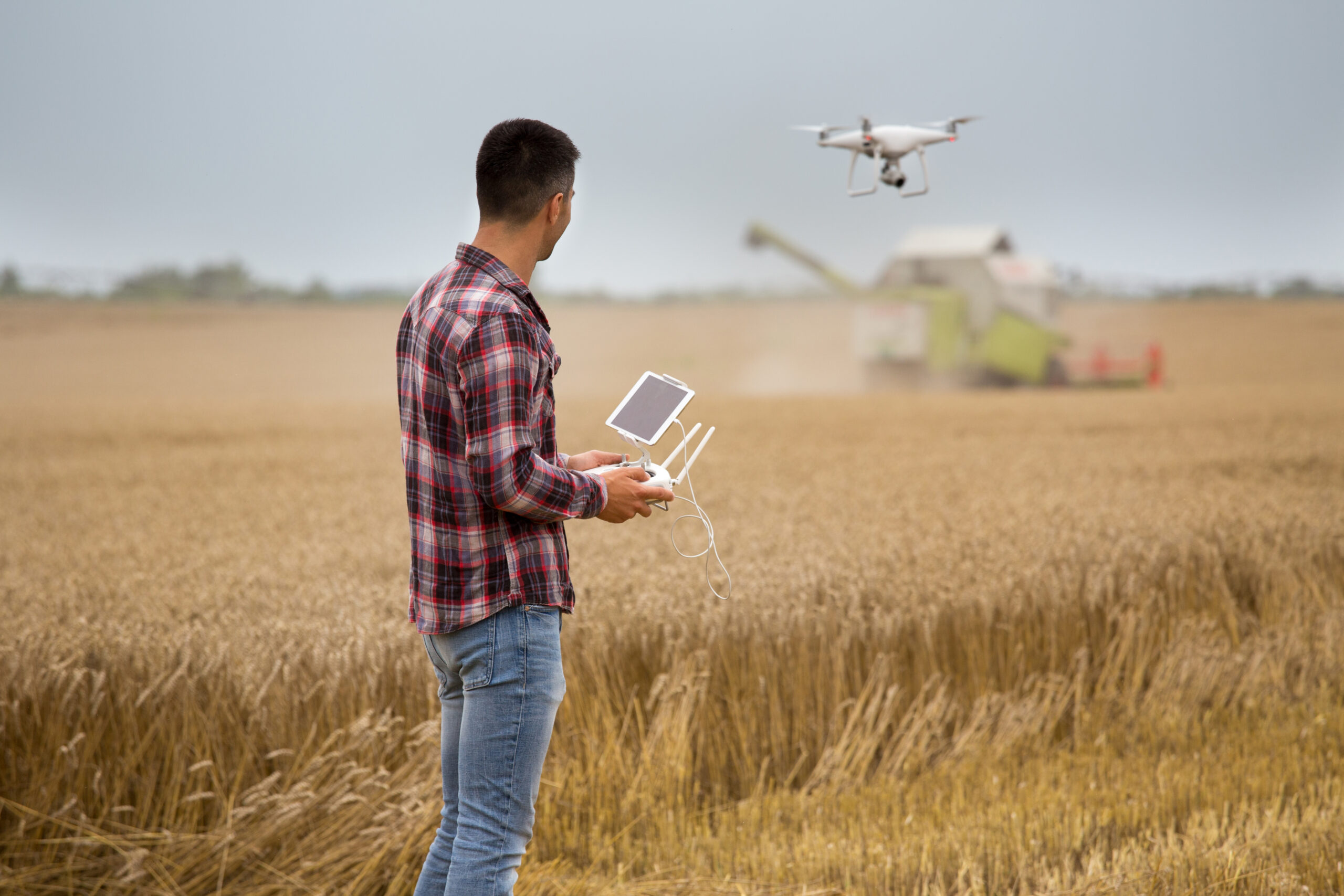 Farmer driving drone;